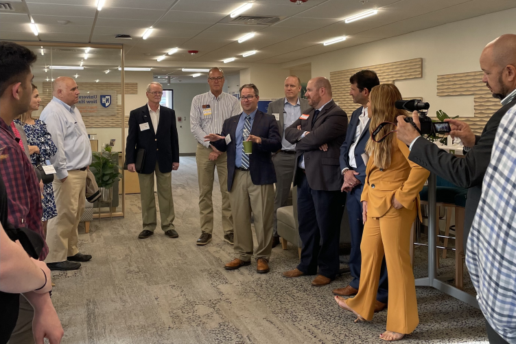 Synectics COO Jeff Spears speaks with people at the UNH Center for Business Analytics